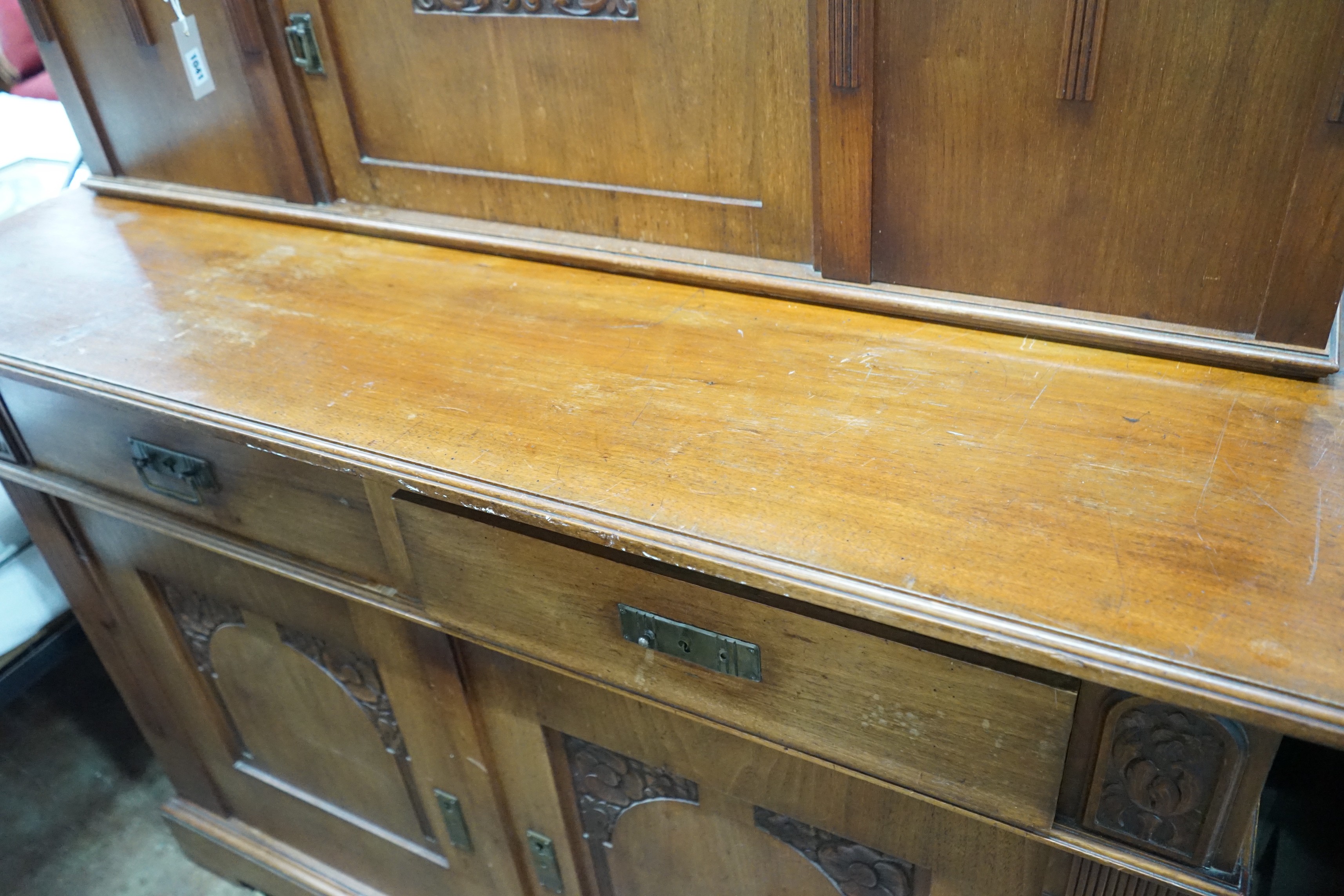 An early 20th century German Art Nouveau walnut buffet, length 141cm, depth 64cm, height 197cm